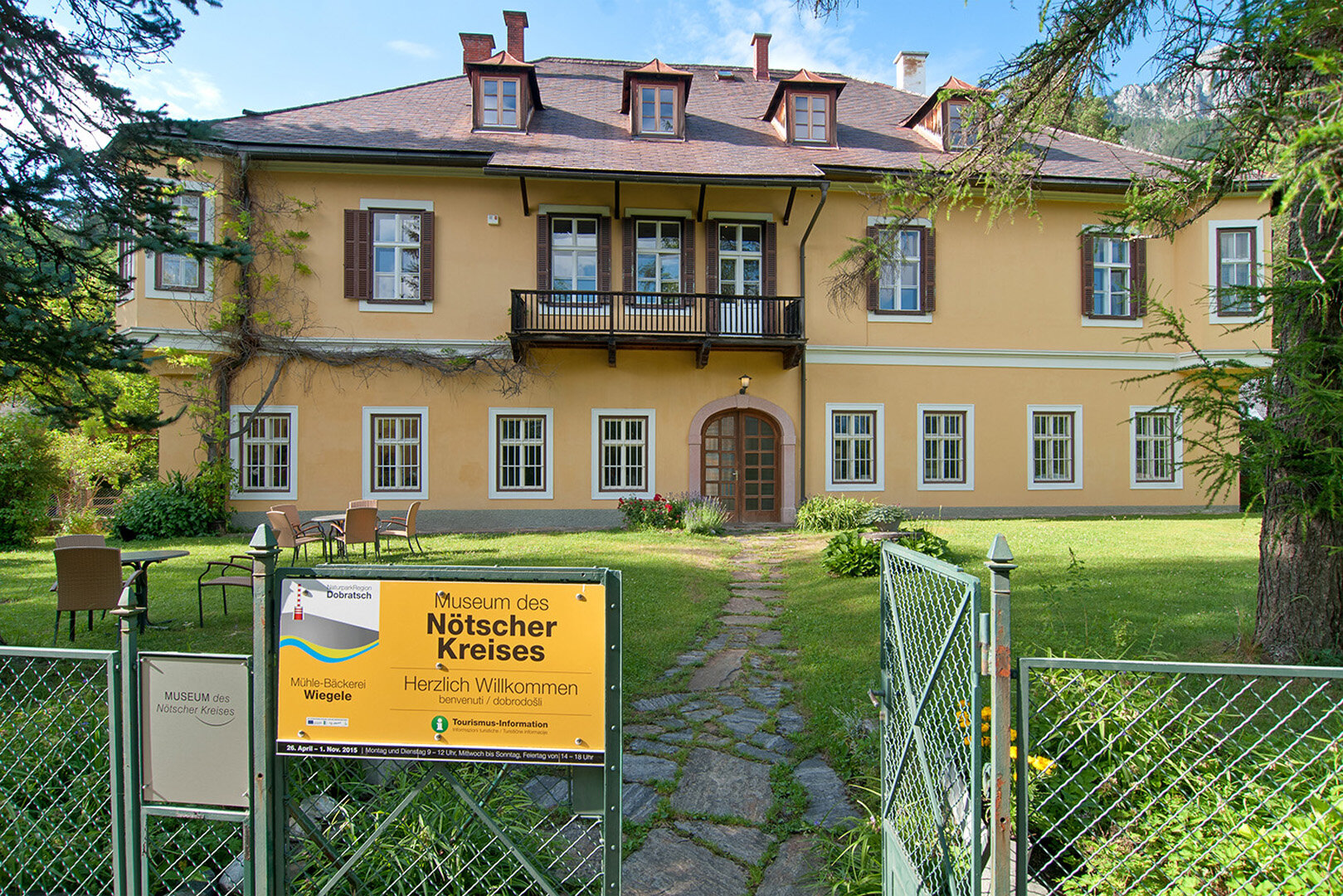 Museum Nötscher Kreis mit gelber Fassade und Garten in Kärnten